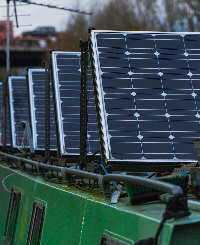 blue solar panels on green metal frame